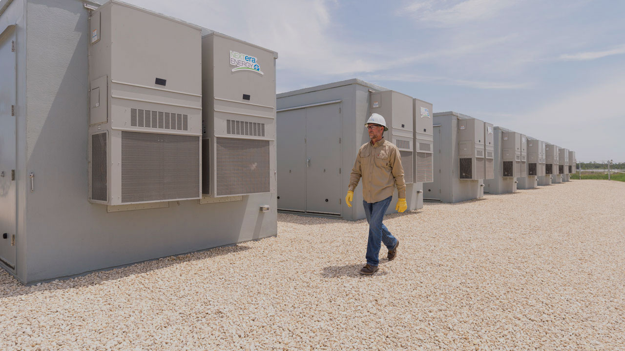 Battery energy storage employee walking in a storage battery area