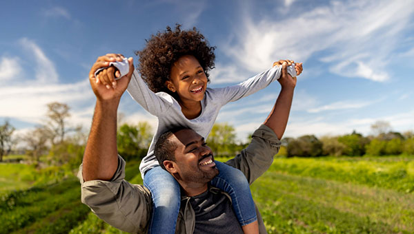 man-daughter-playing-field